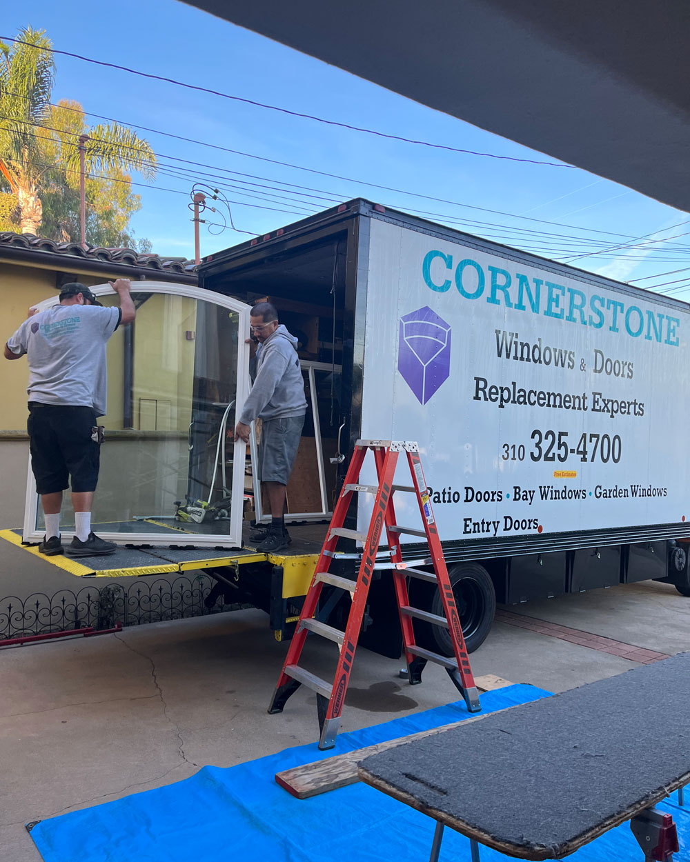 cornerstone windows employees unload a window from their truck